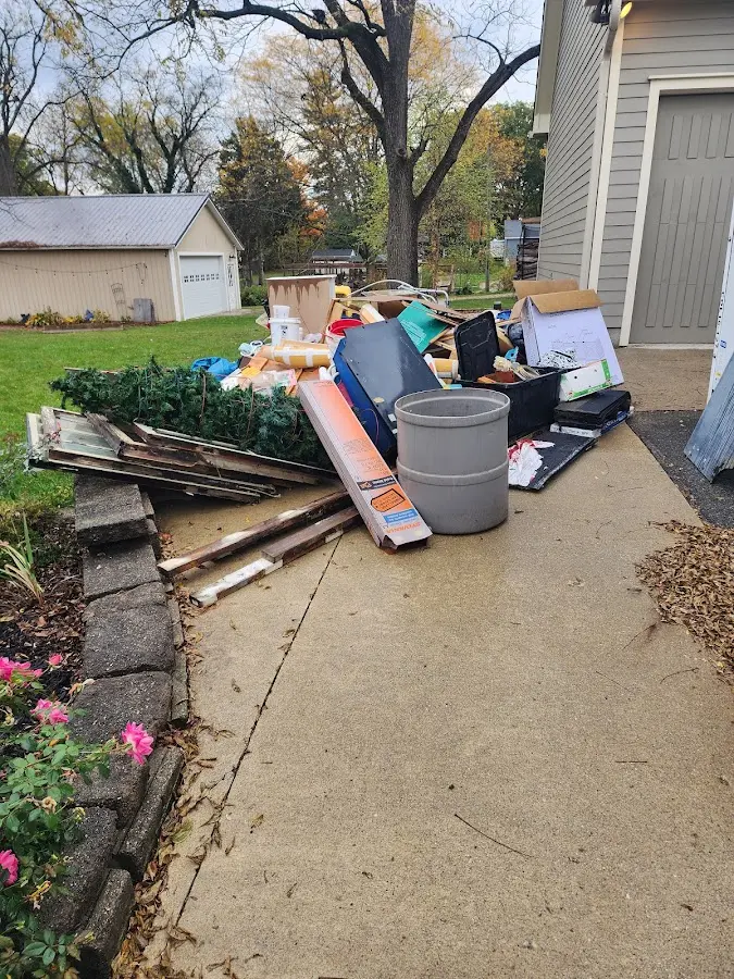 Dumpster being loaded with debris for Estate Cleanout Dumpster Rental in Toms River